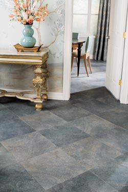 natural stone-look luxury vinyl tile in entryway with accent wall and flowers